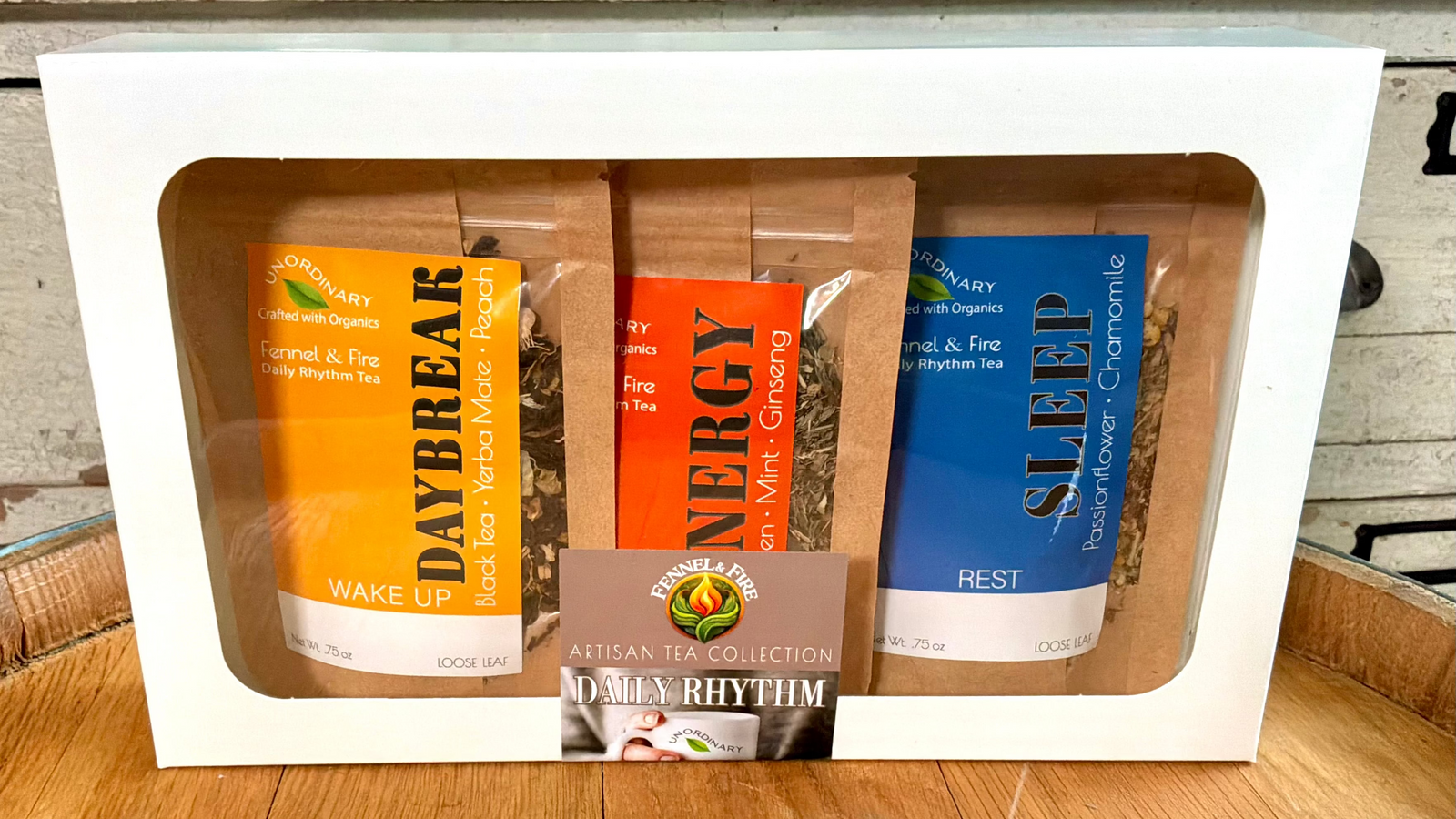 A boxed tea gift set with three tea bags visible through a white window box. The packages are labeled Daybreak, Energy, and Sleep, with a central card reading 'A Man's Rhythm'.