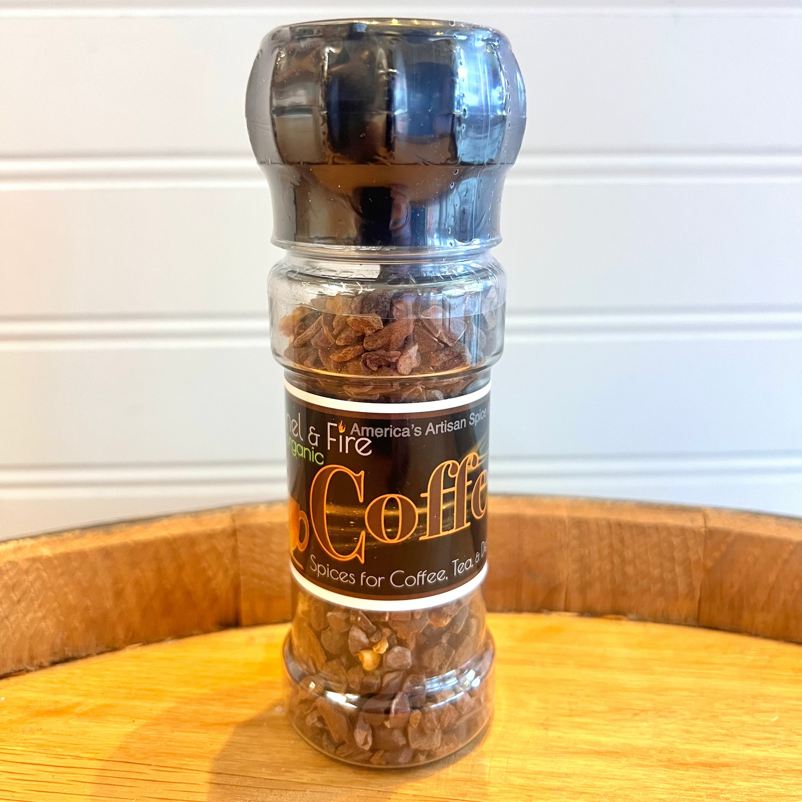 grinder labeled 'Coffee Twist' on a wooden surface with a white background