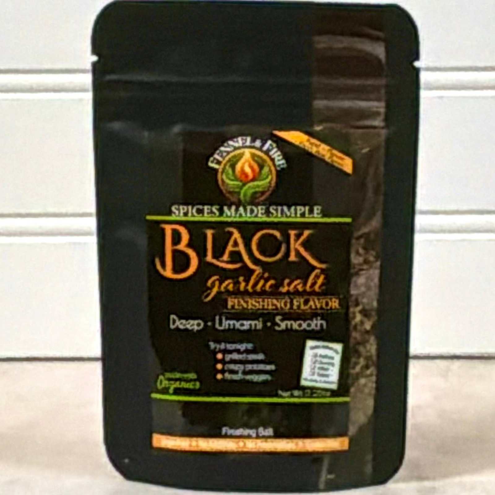 Black garlic salt packaging with 'Spices Made Simple' branding on a white background