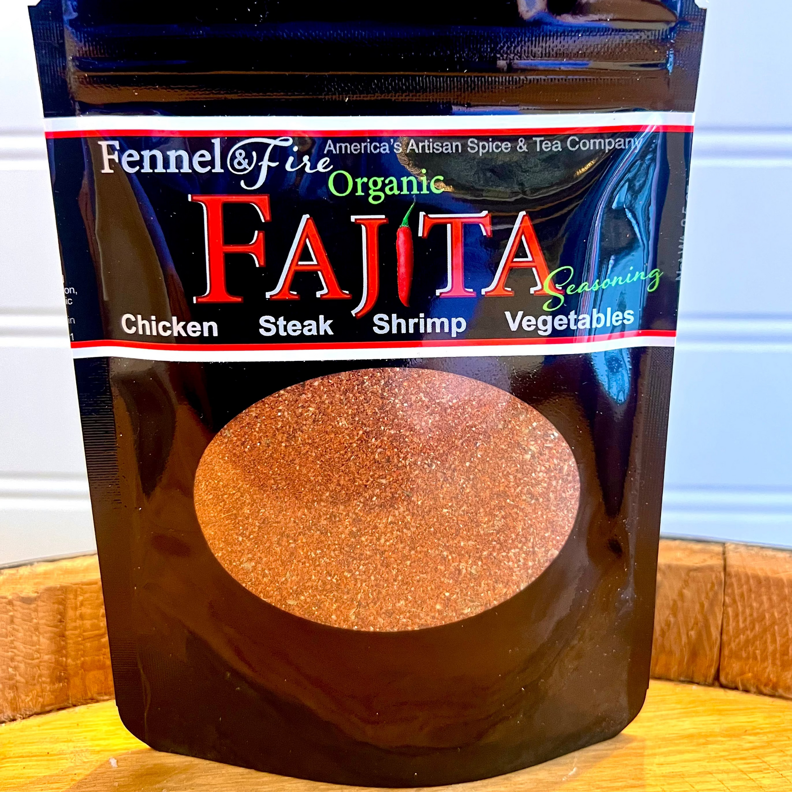 Bag of Fajita seasoning on wooden barrel with white background