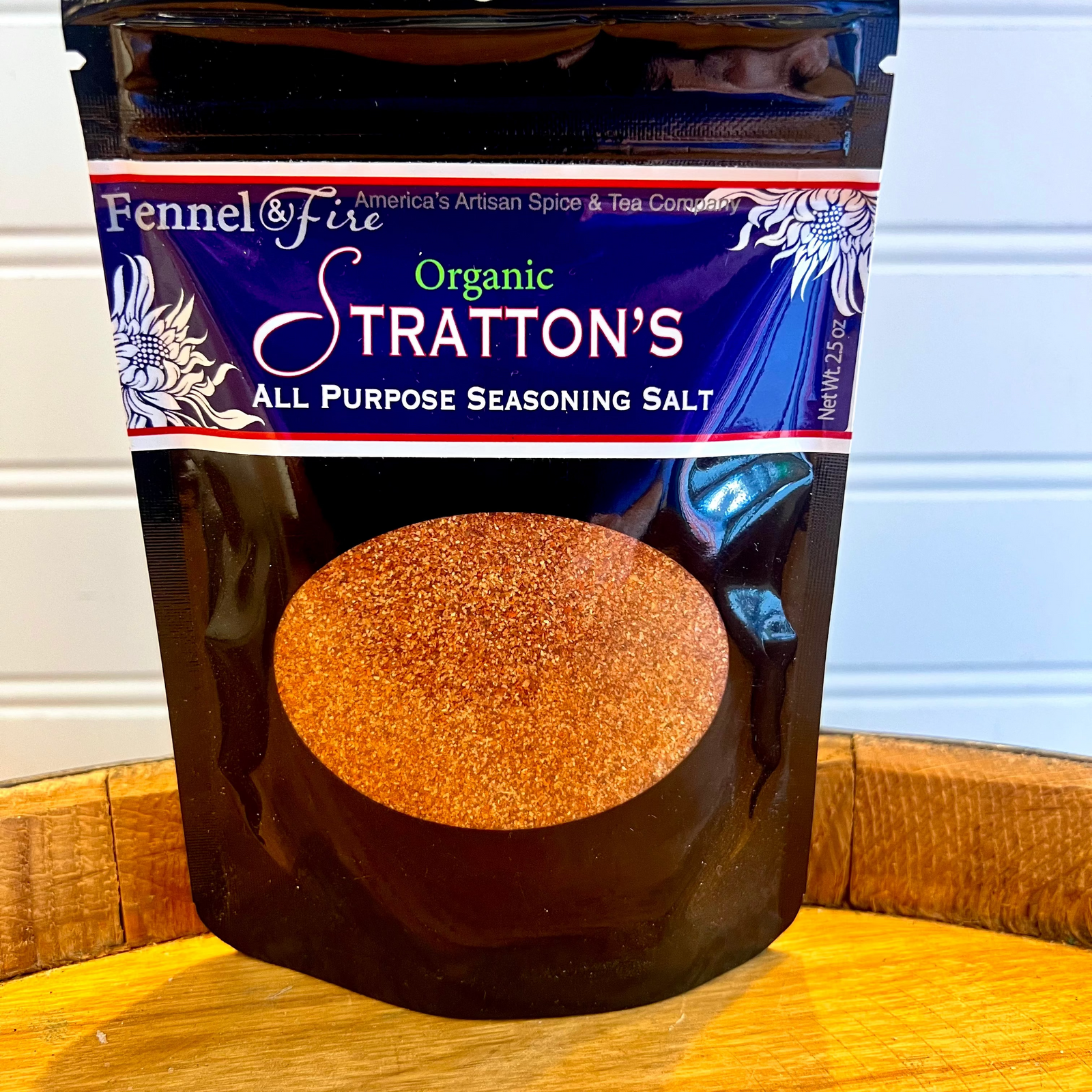 A Bag or All Purpose Stratton's Seasoning salt on a wooden barrel with a white background