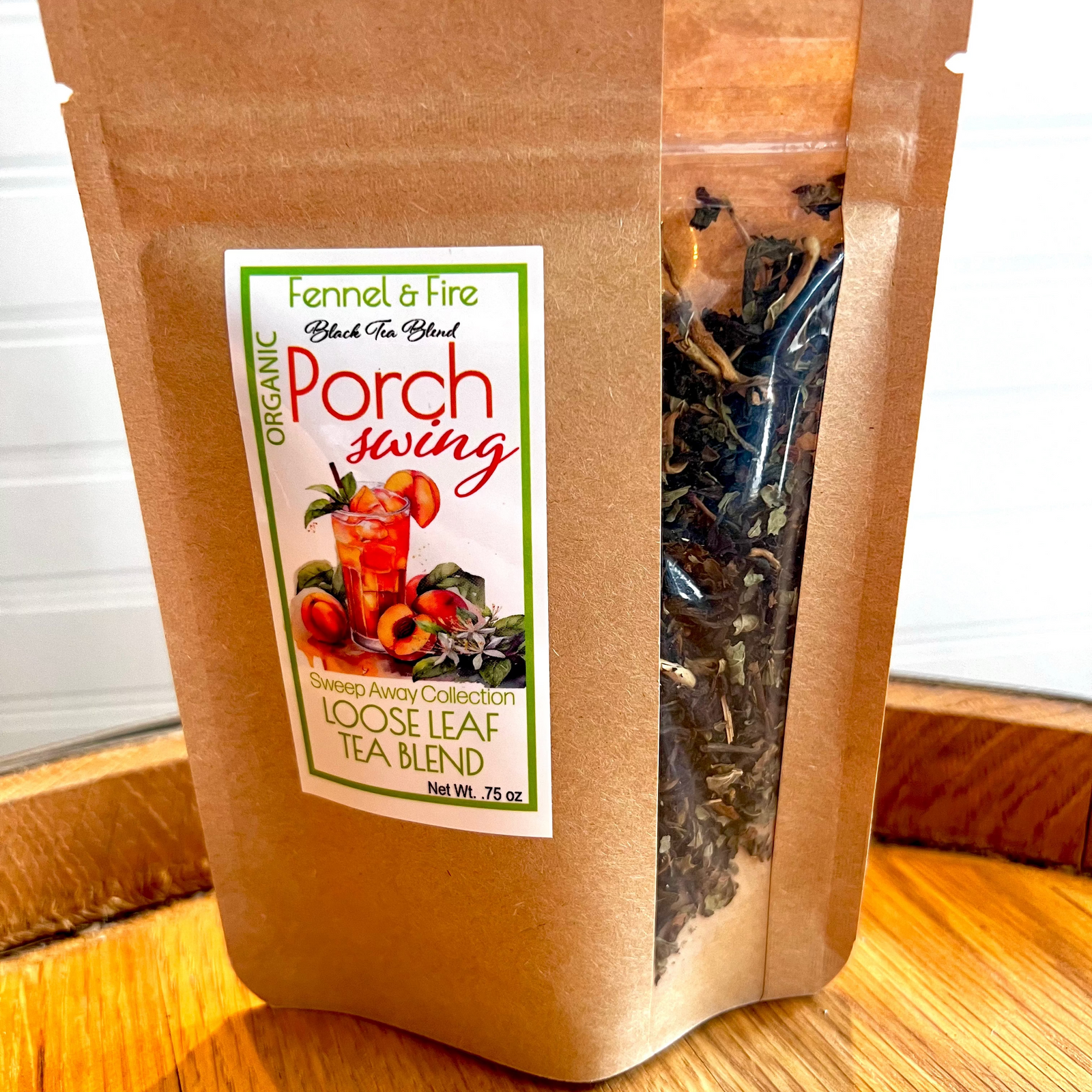 A package of Porch Swing Loose Leaf Tea Blend with a clear window showing the blend of tea leaves and fruits inside.