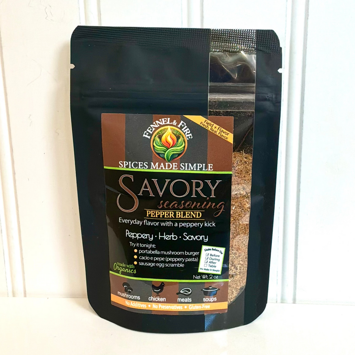 A black resealable stand-up pouch of Kennesa & Fine Savory Seasoning Pepper Blend, displayed against a white paneled background.