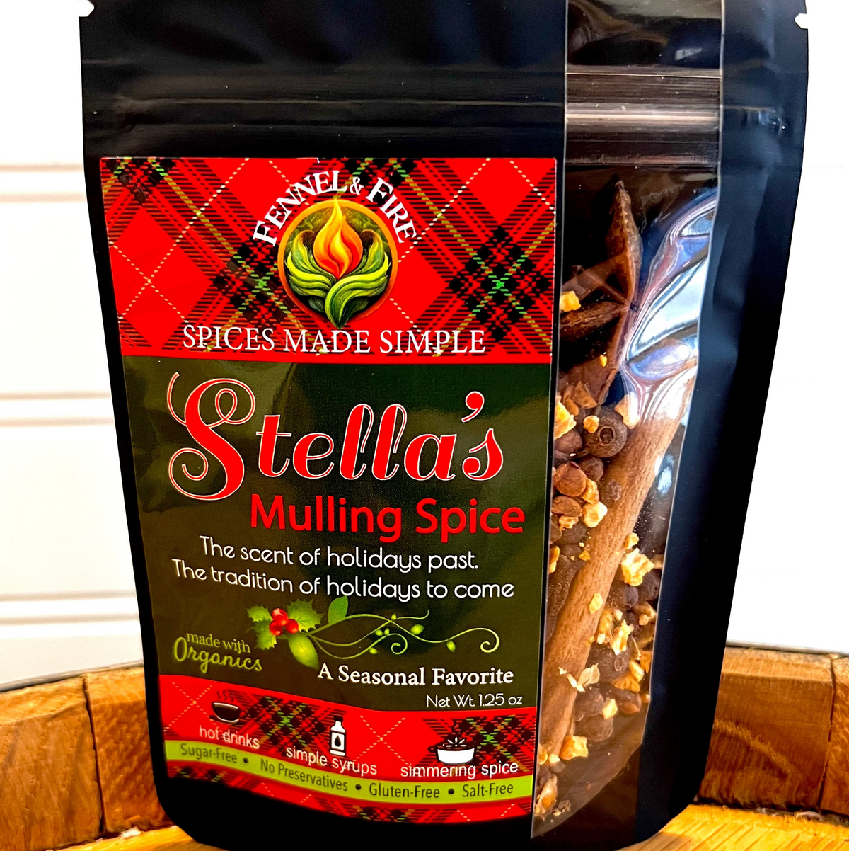Package of Stella's Mulling Spice with visible spices inside on a wooden surface.