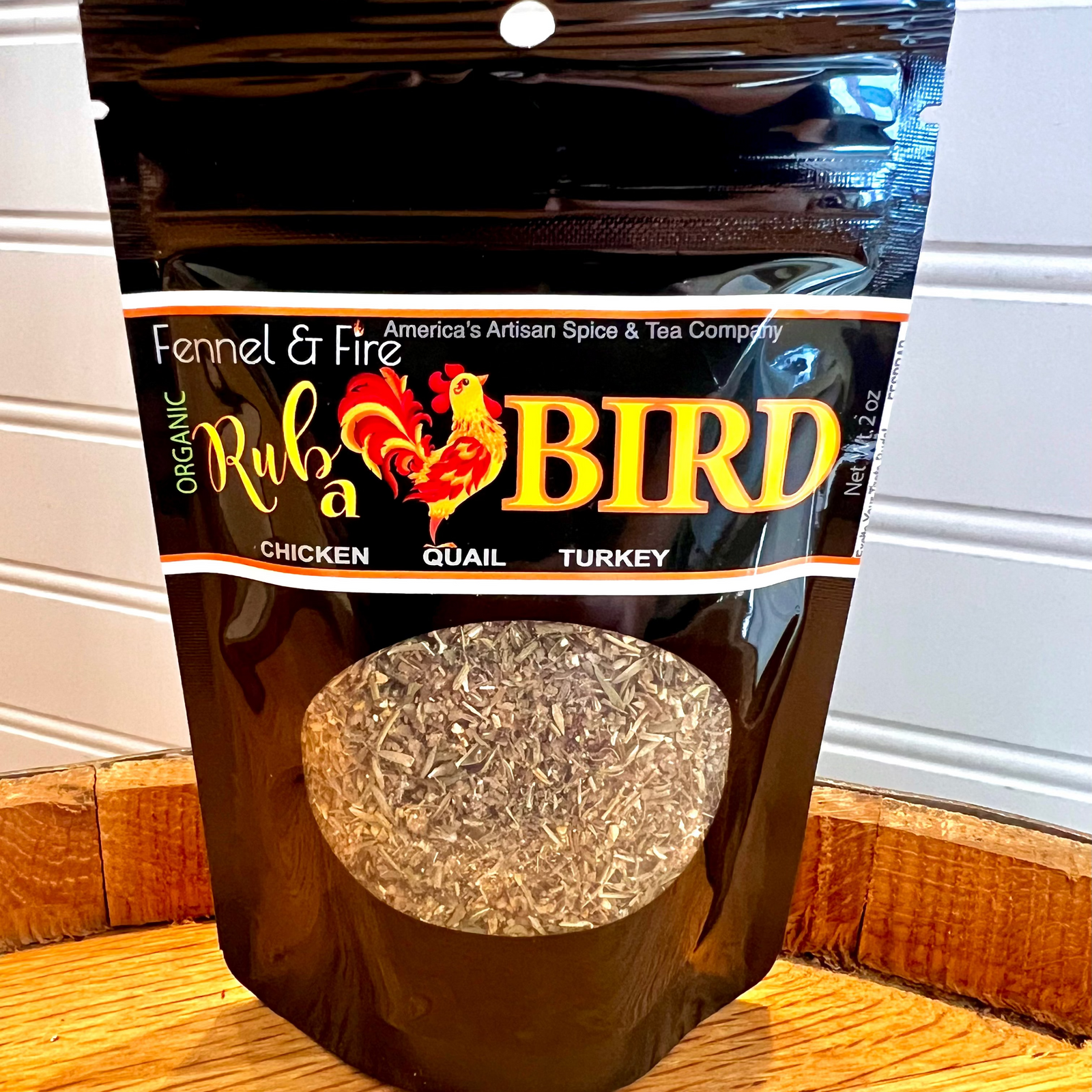 Package of Fennel & Fire Rub a Bird seasoning on a wooden surface.